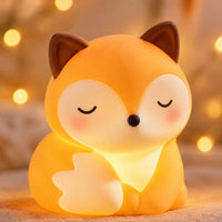 Close-up of the soft silicone fox night light's face, glowing warmly